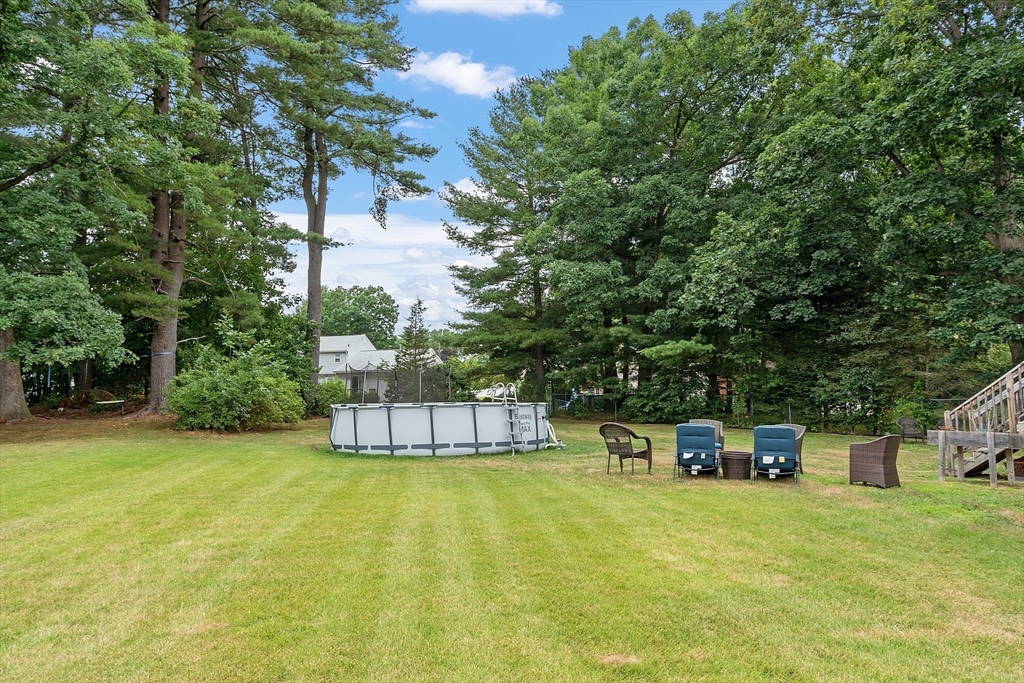 9 Springwell Road Billerica, MA 01821 - Photo 32 of 37 a view of a swimming pool with a bench and trees