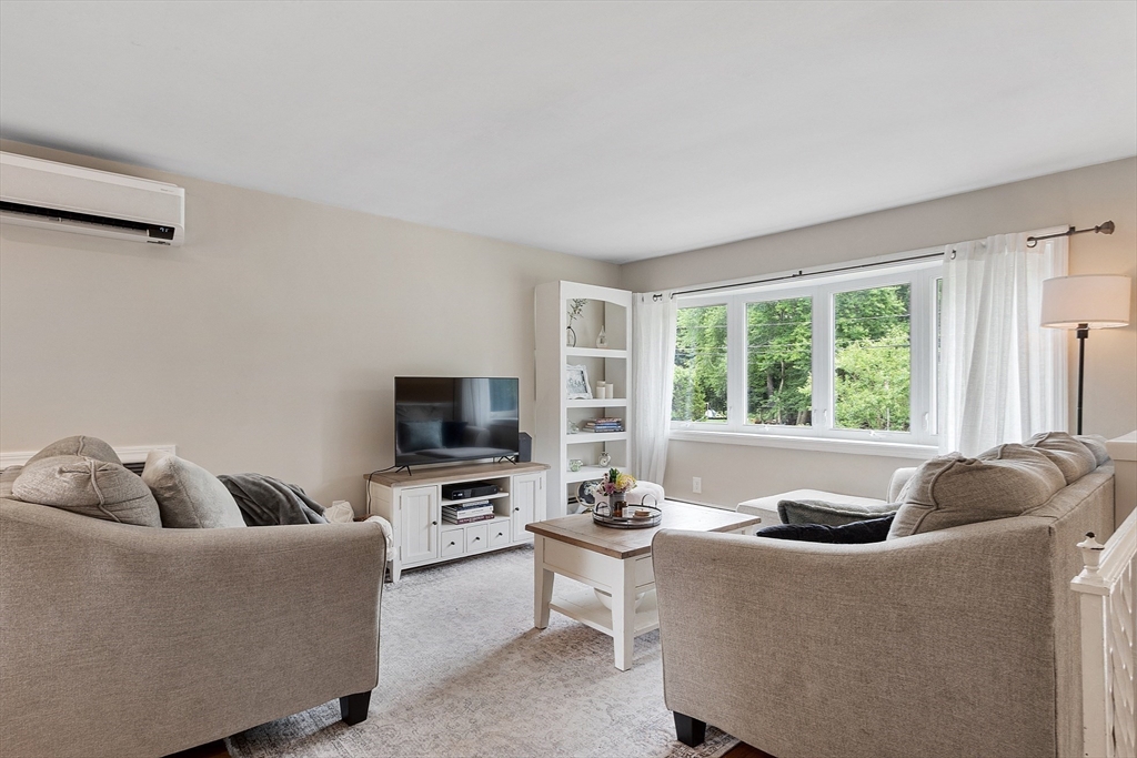9 Springwell Road Billerica, MA 01821 - Photo 4 of 37 a living room with furniture and a flat screen tv