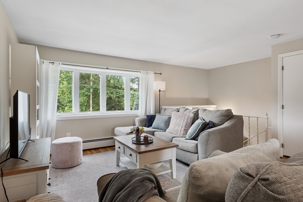 9 Springwell Road Billerica, MA 01821 - Photo 6 of 37 a bedroom with a bed and a couch