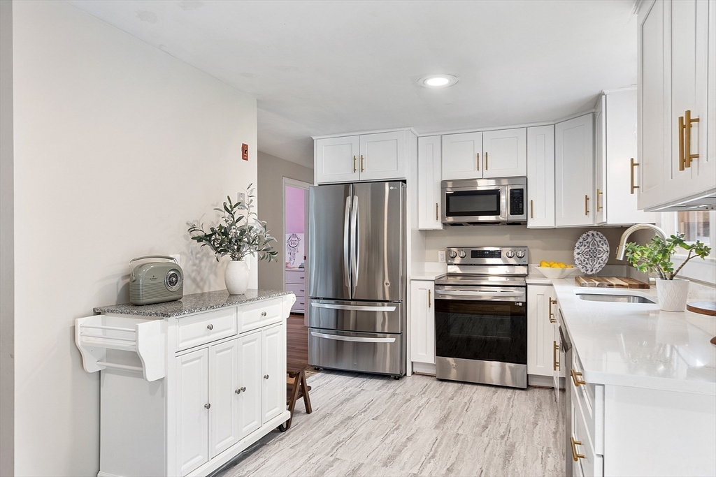 9 Springwell Road Billerica, MA 01821 - Photo 10 of 37 a kitchen with stainless steel appliances a stove refrigerator sink and microwave