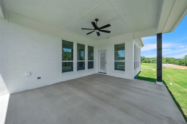 a view of an empty room with a fireplace and a large window