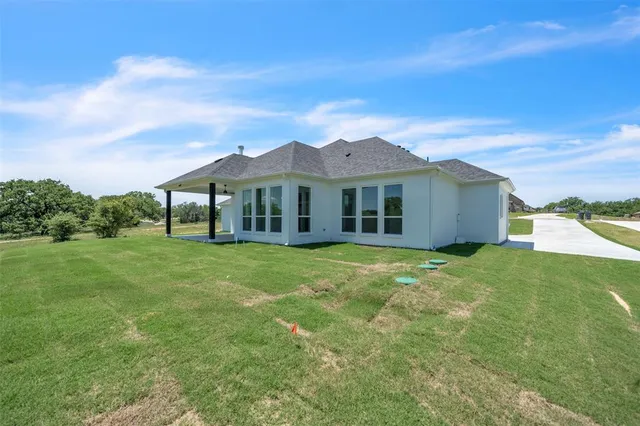 a view of a house with a backyard