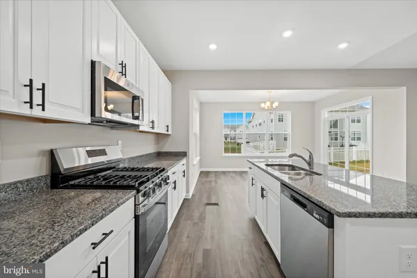 a kitchen with stainless steel appliances granite countertop a stove and a sink