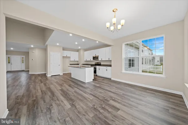 a view of kitchen with granite countertop cabinets and wooden floor
