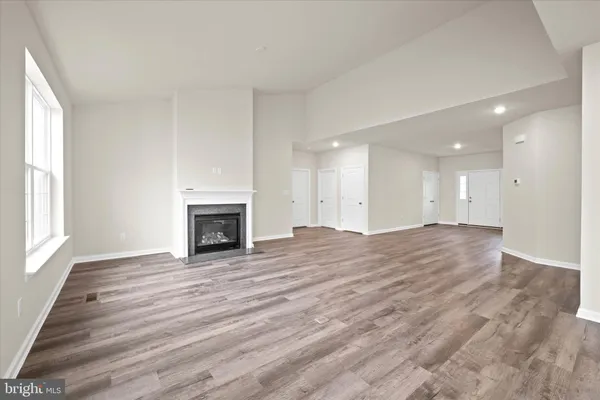 a view of an empty room with window and fire place