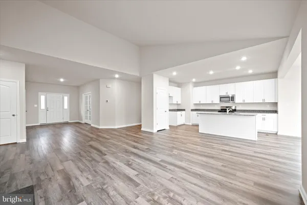 a view of kitchen with kitchen island and stainless steel appliances