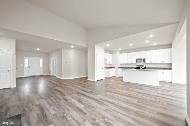 a view of kitchen with kitchen island and stainless steel appliances