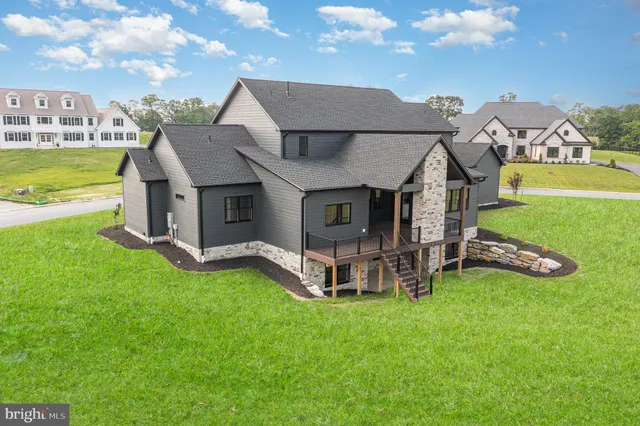 a view of a house with a yard and sitting area