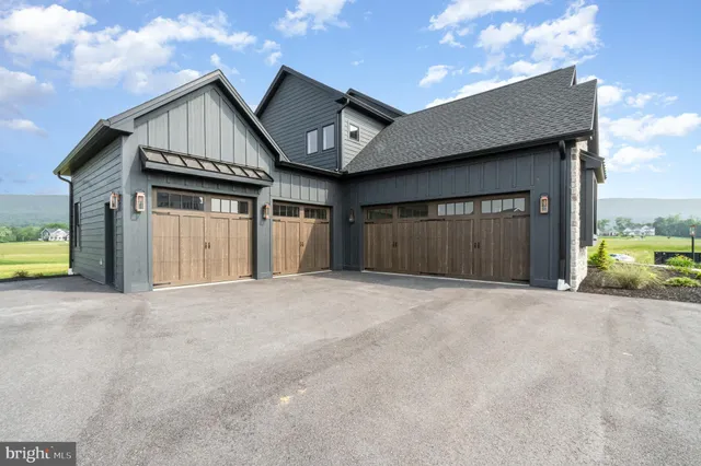 a living room with furniture a fireplace and a large window