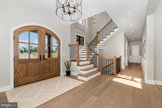a living room with furniture a fireplace and a large mirror