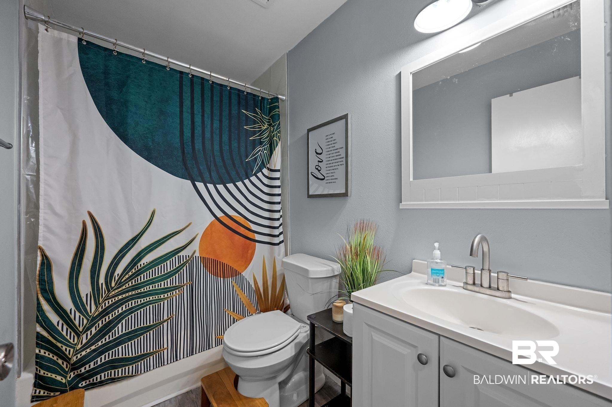 4724 Wicker Way Mobile, AL 36609 - Photo 23 of 36 Bathroom featuring a white vanity with an undermount sink and brushed nickel faucet, a white-framed mirror, and a toilet