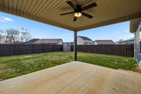 a view of a backyard with wooden fence
