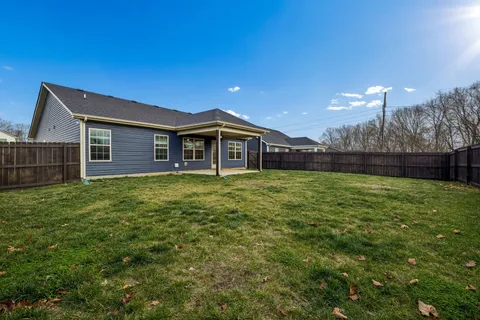 a view of a house with a backyard