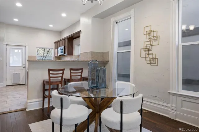 a dining room with furniture and wooden floor