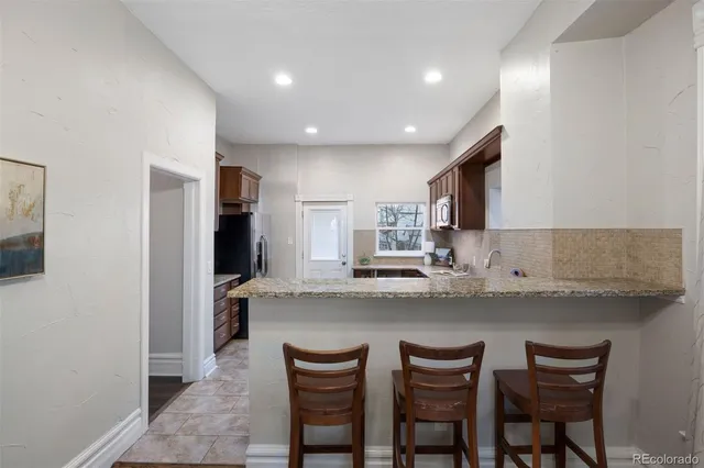 a kitchen with refrigerator and cabinets