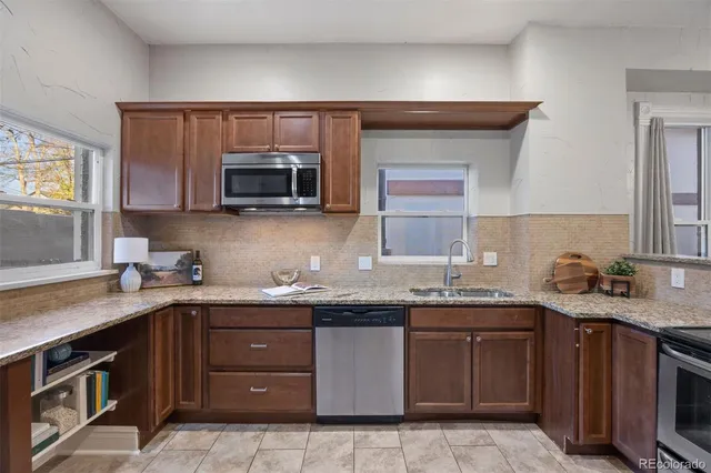 a kitchen with a sink and a stove top oven