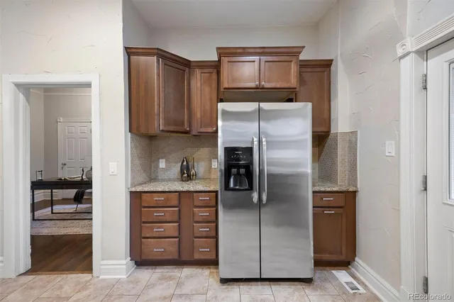 a kitchen with stainless steel appliances granite countertop a refrigerator and a stove