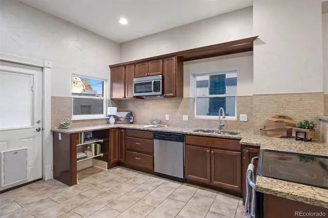 a kitchen with a sink stove and microwave