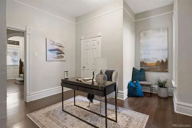 a living room with furniture and wooden floor