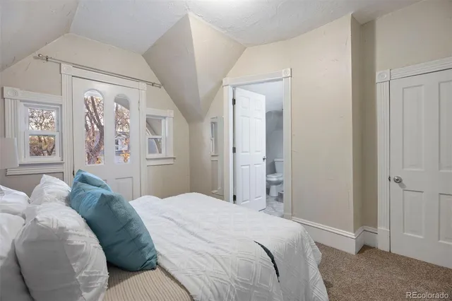 a bedroom with a bed and a mirror