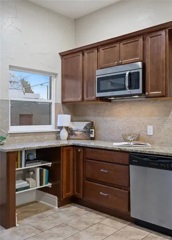 a kitchen with stainless steel appliances a stove microwave and cabinets