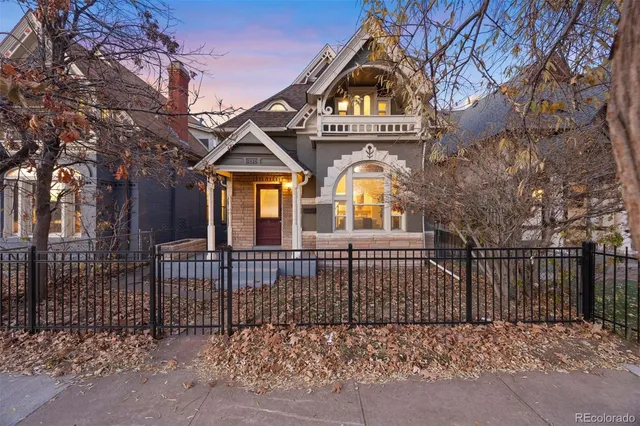 a front view of a house with a iron gate