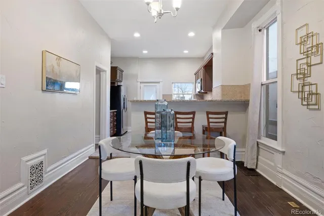 a dining room with furniture and wooden floor