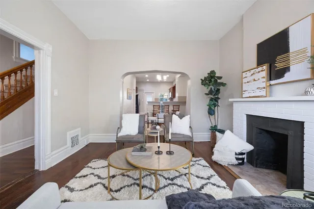 a living room with furniture a fireplace and a flat screen tv