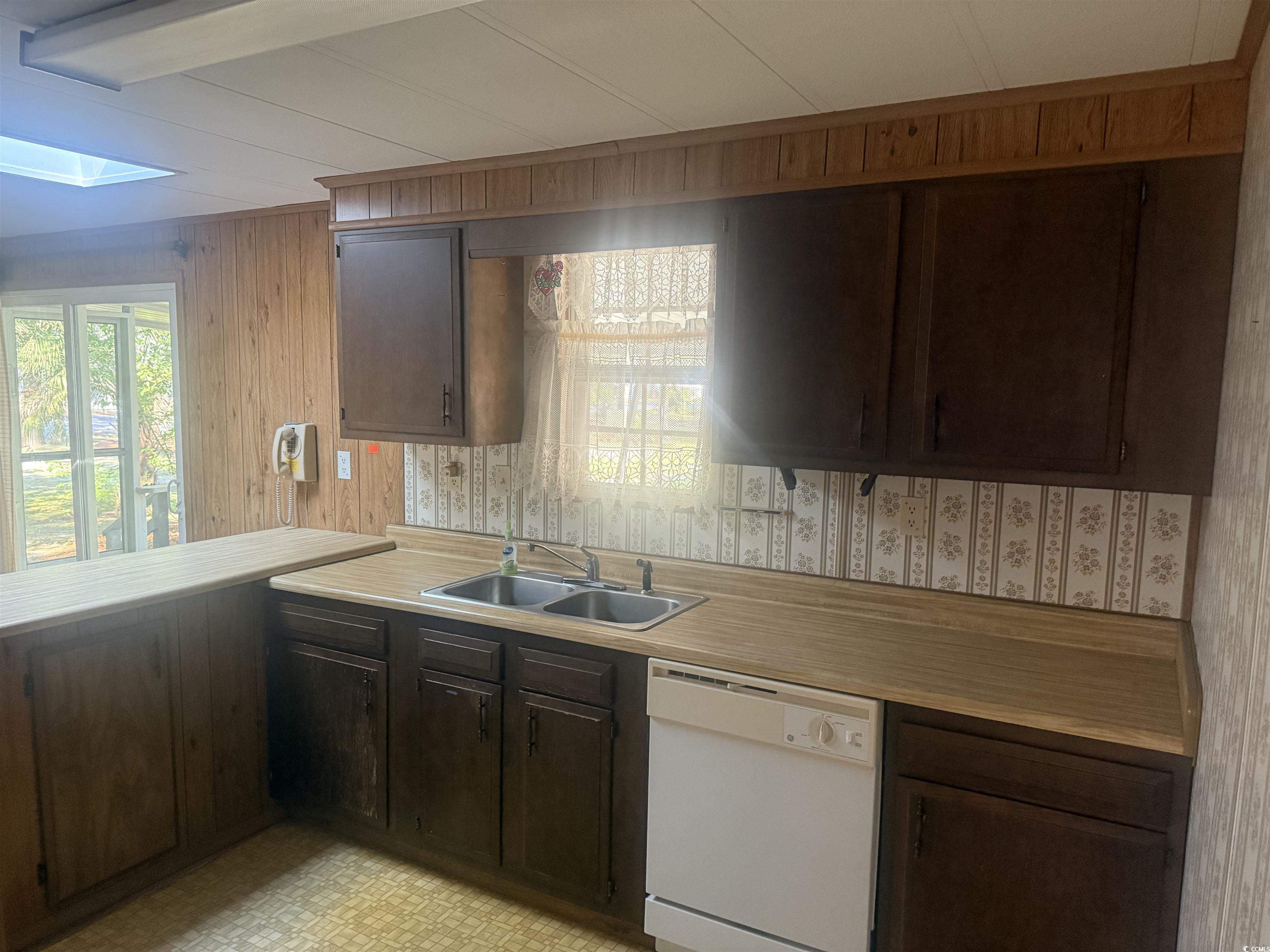 712 Raleigh Trail Murrells Inlet, SC 29576 - Photo 12 of 32 Carpeted spare room with ceiling fan and wooden walls