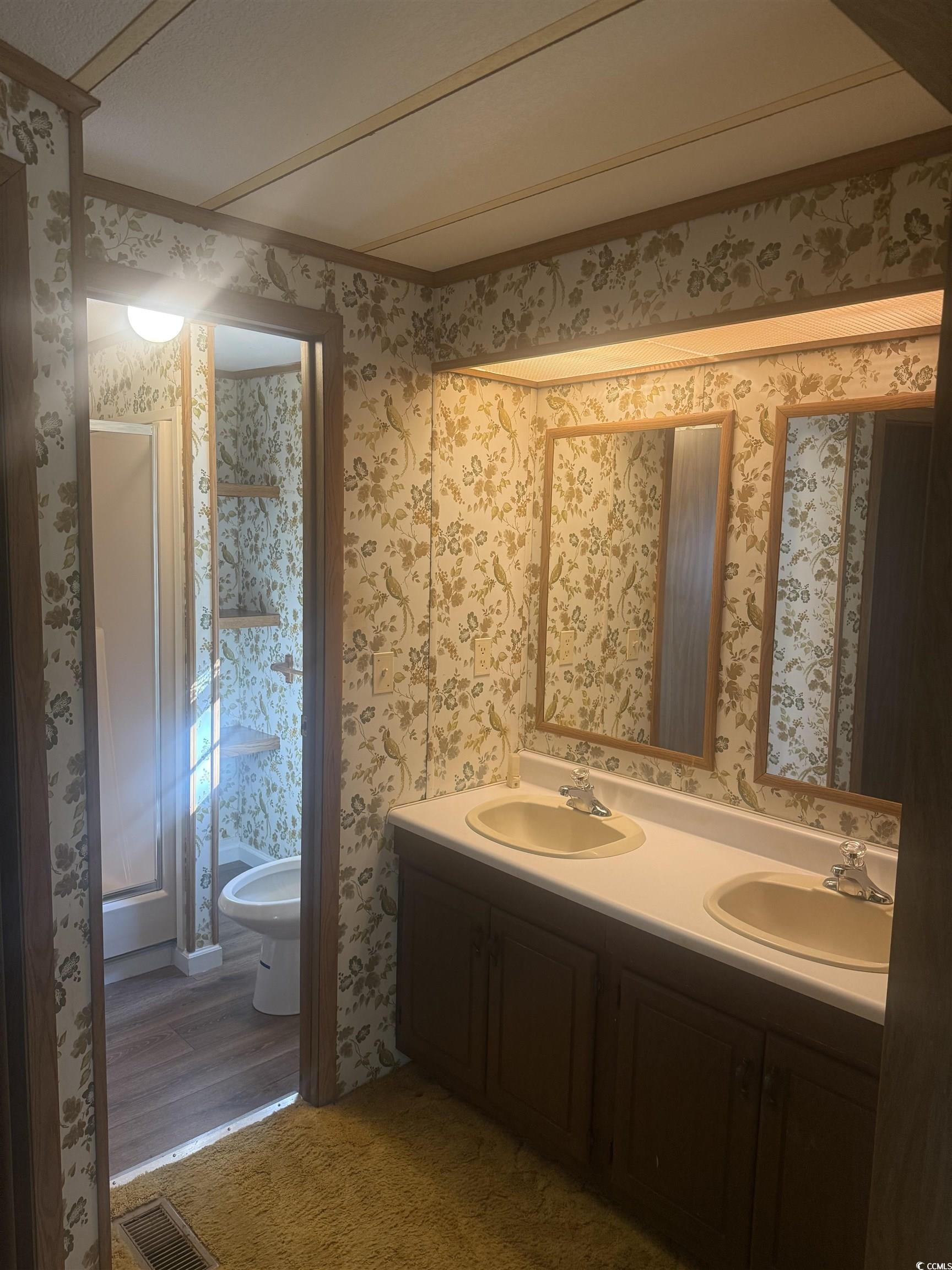 712 Raleigh Trail Murrells Inlet, SC 29576 - Photo 17 of 32 Kitchen featuring white appliances, light countertops, a peninsula, light floors, and under cabinet range hood