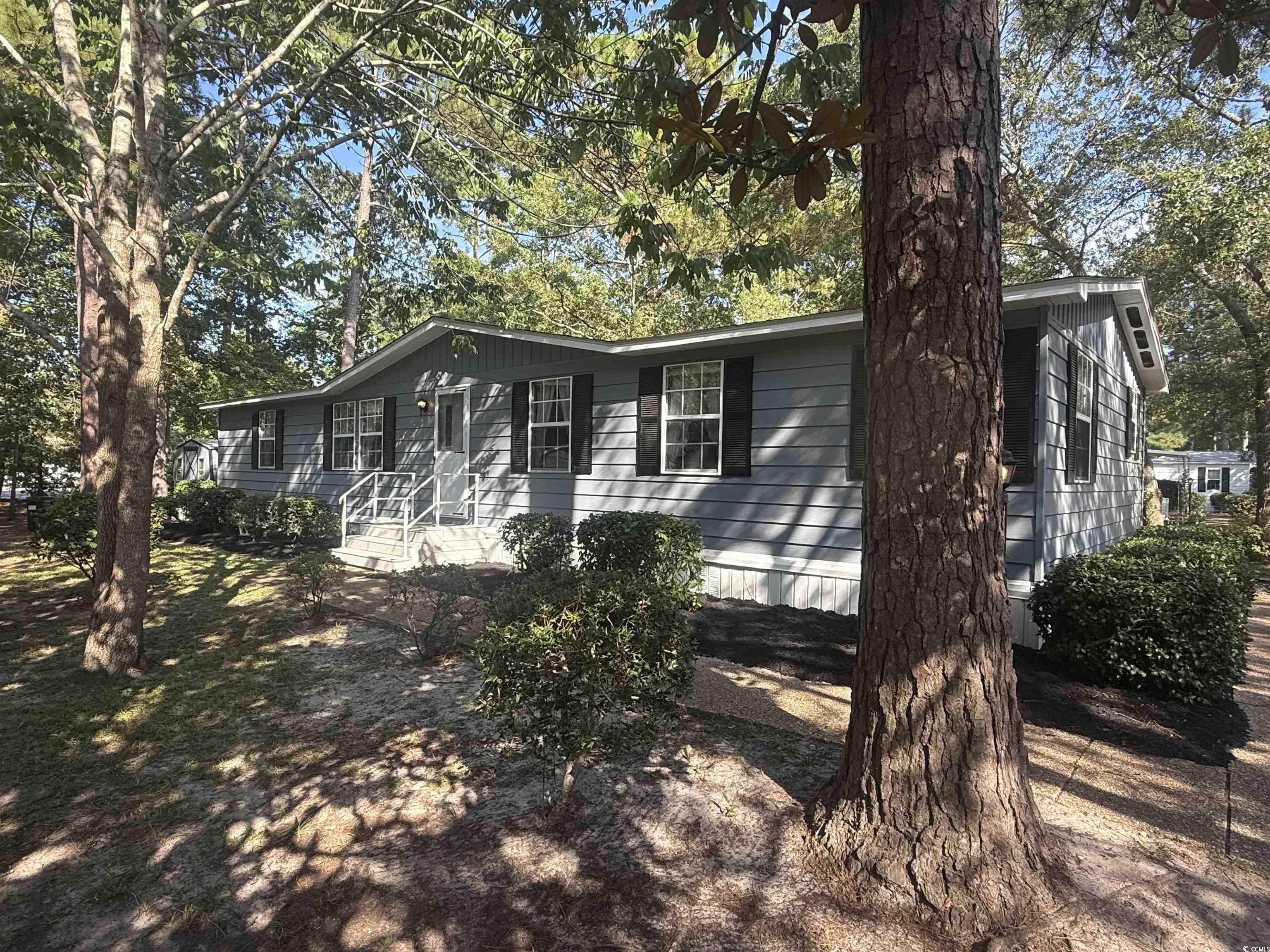 712 Raleigh Trail Murrells Inlet, SC 29576 - Photo 4 of 32 View of front of house featuring a sunroom and a front lawn