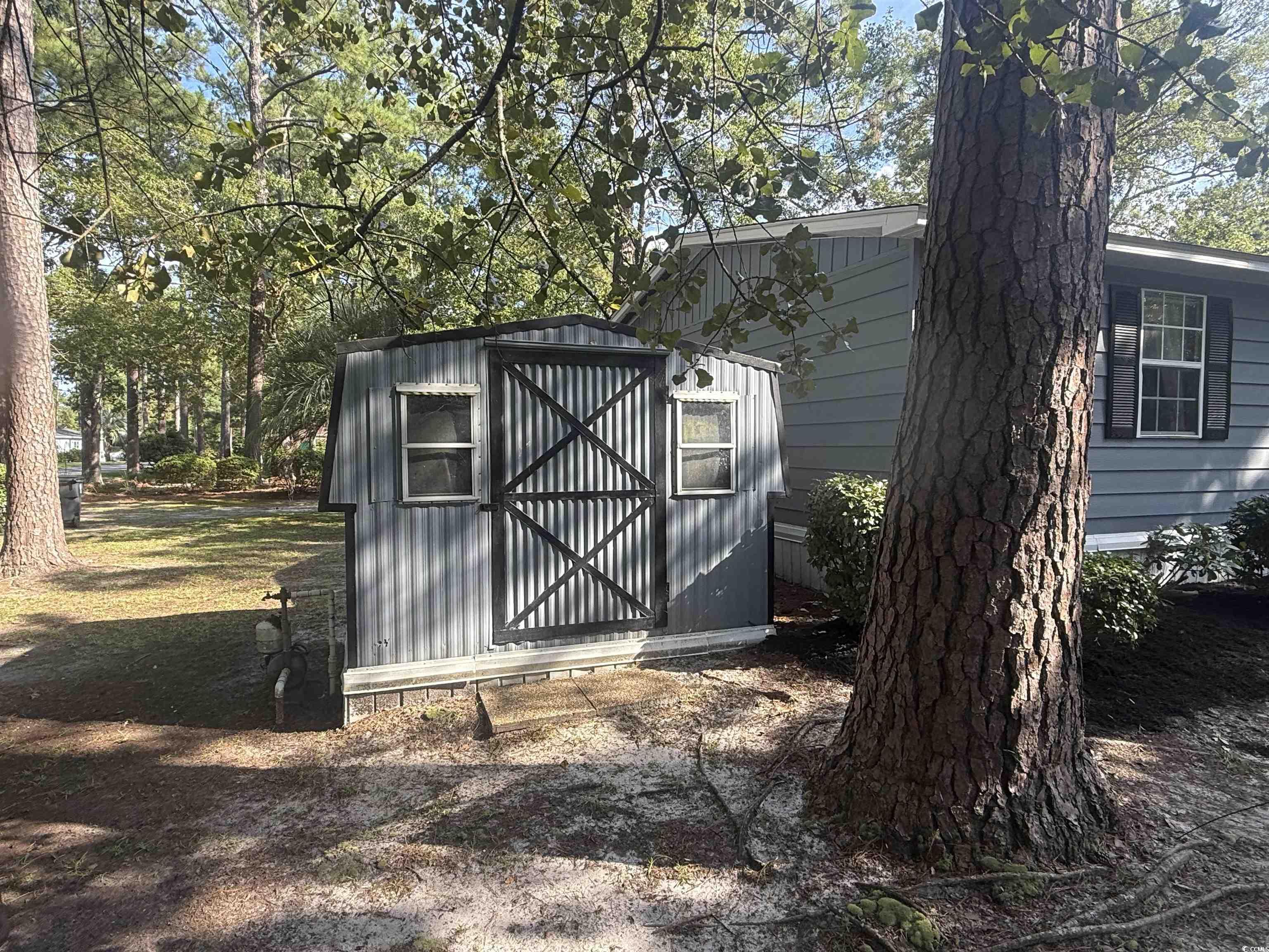 712 Raleigh Trail Murrells Inlet, SC 29576 - Photo 5 of 32 View of side of home featuring a sunroom