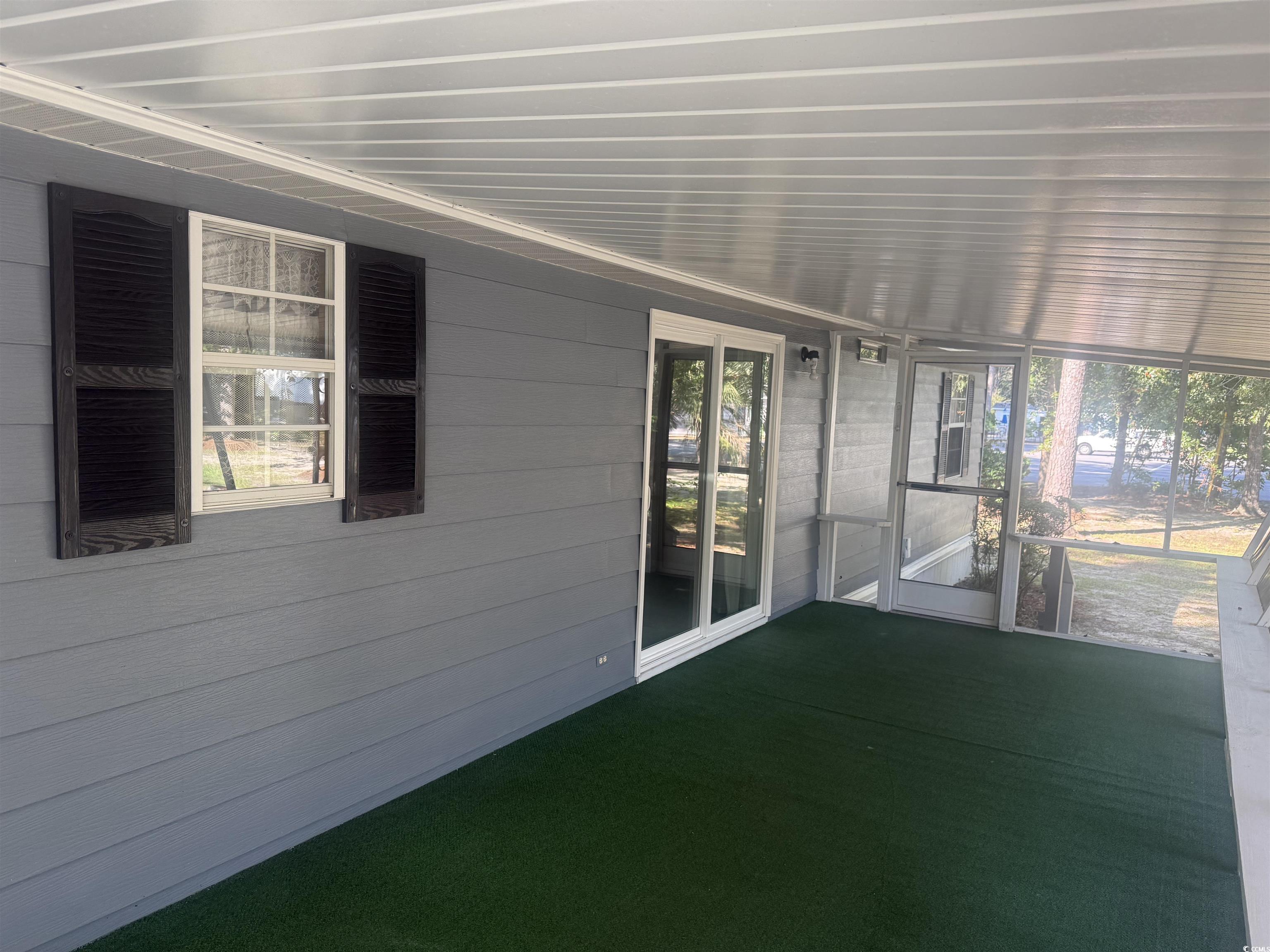 712 Raleigh Trail Murrells Inlet, SC 29576 - Photo 8 of 32 View of home's exterior with a sunroom and a central air condition unit