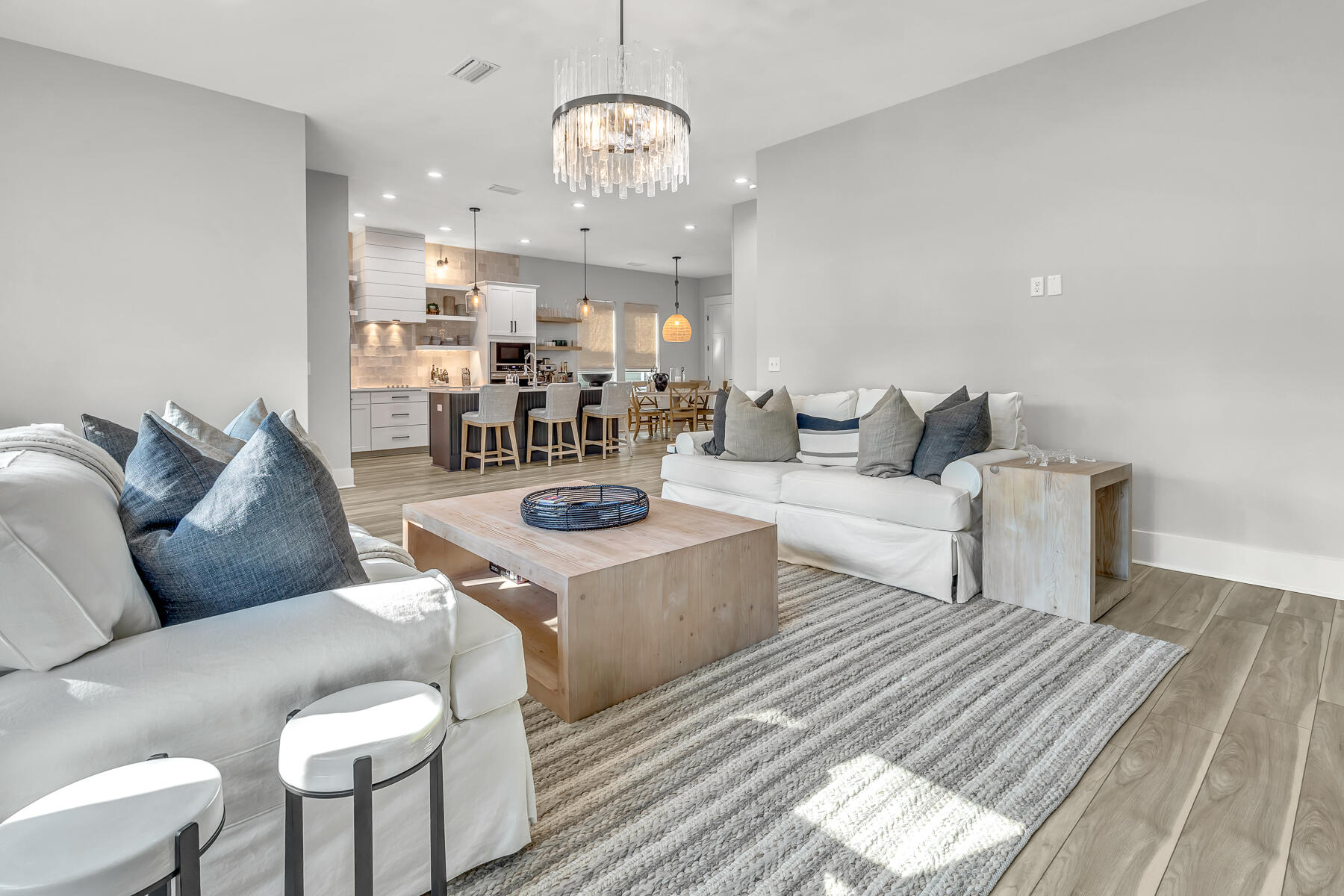 106 Marlberry Santa Rosa Beach Santa Rosa Beach, FL 32459 - Photo 17 of 37 a living room with furniture a chandelier and a dining table with wooden floor