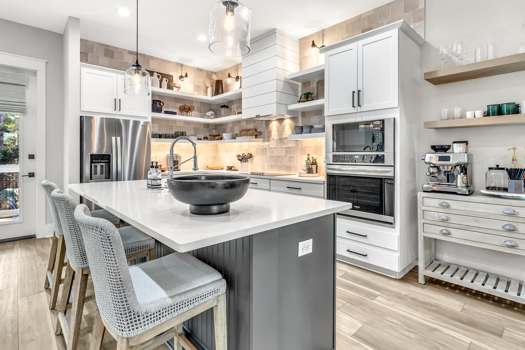 106 Marlberry Santa Rosa Beach Santa Rosa Beach, FL 32459 - Photo 9 of 37 a kitchen with stainless steel appliances kitchen island granite countertop a table chairs in it and wooden floors