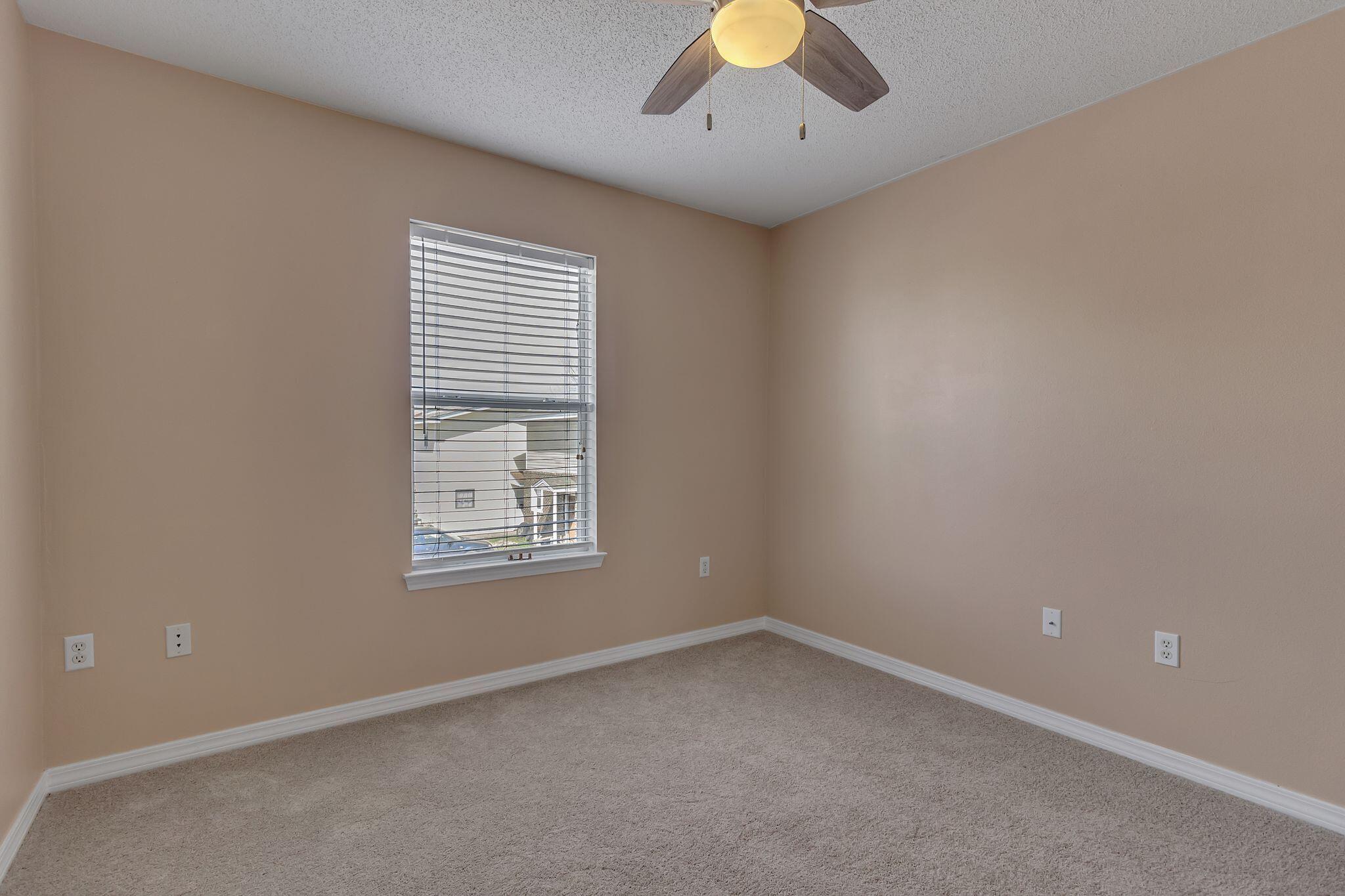 150 Bent Arrow Drive, Unit 51 Destin, FL 32541 - Photo 18 of 28 an empty room with a window and chandelier fan