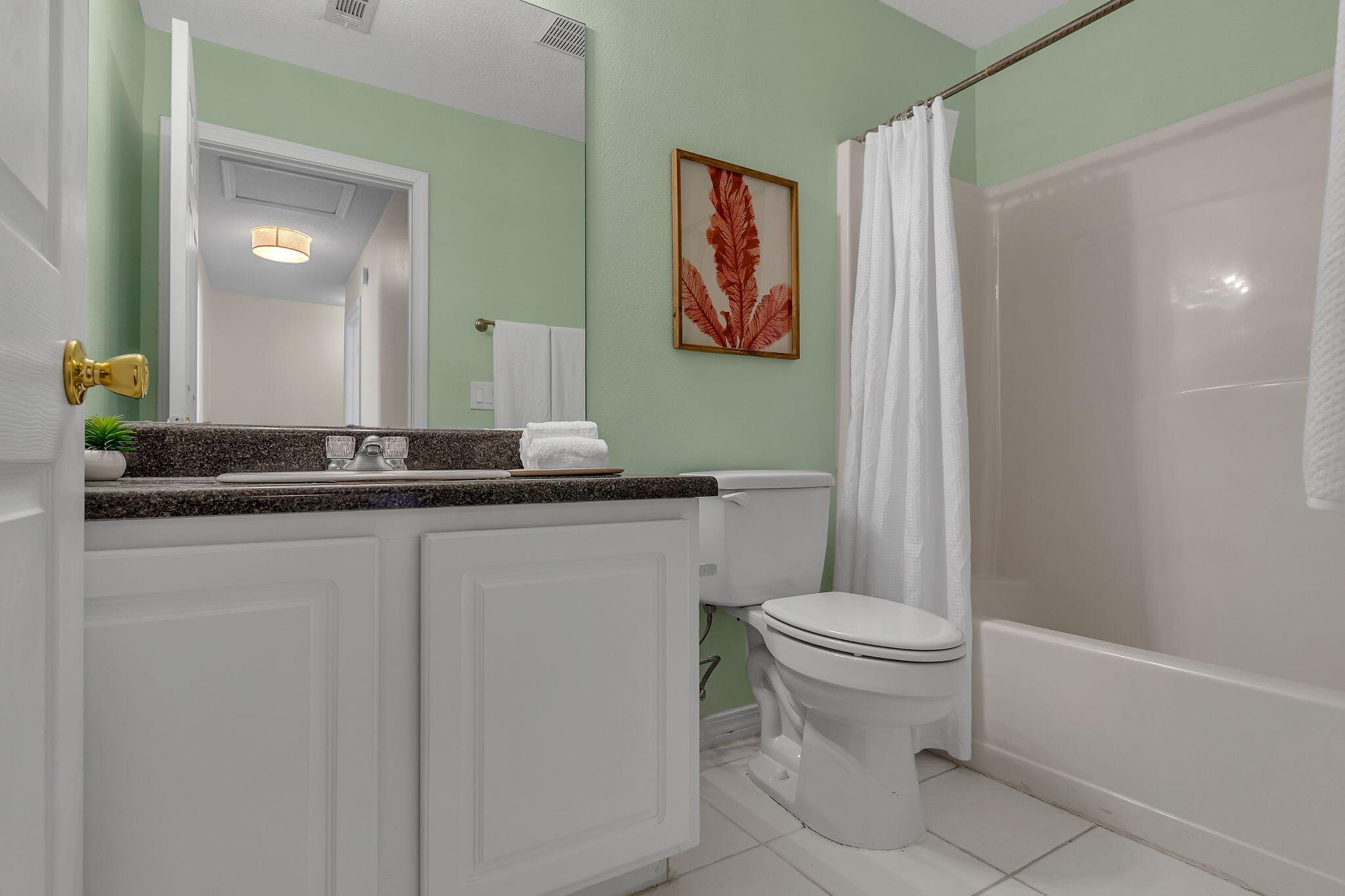 150 Bent Arrow Drive, Unit 51 Destin, FL 32541 - Photo 21 of 28 a bathroom with a toilet a sink and a mirror