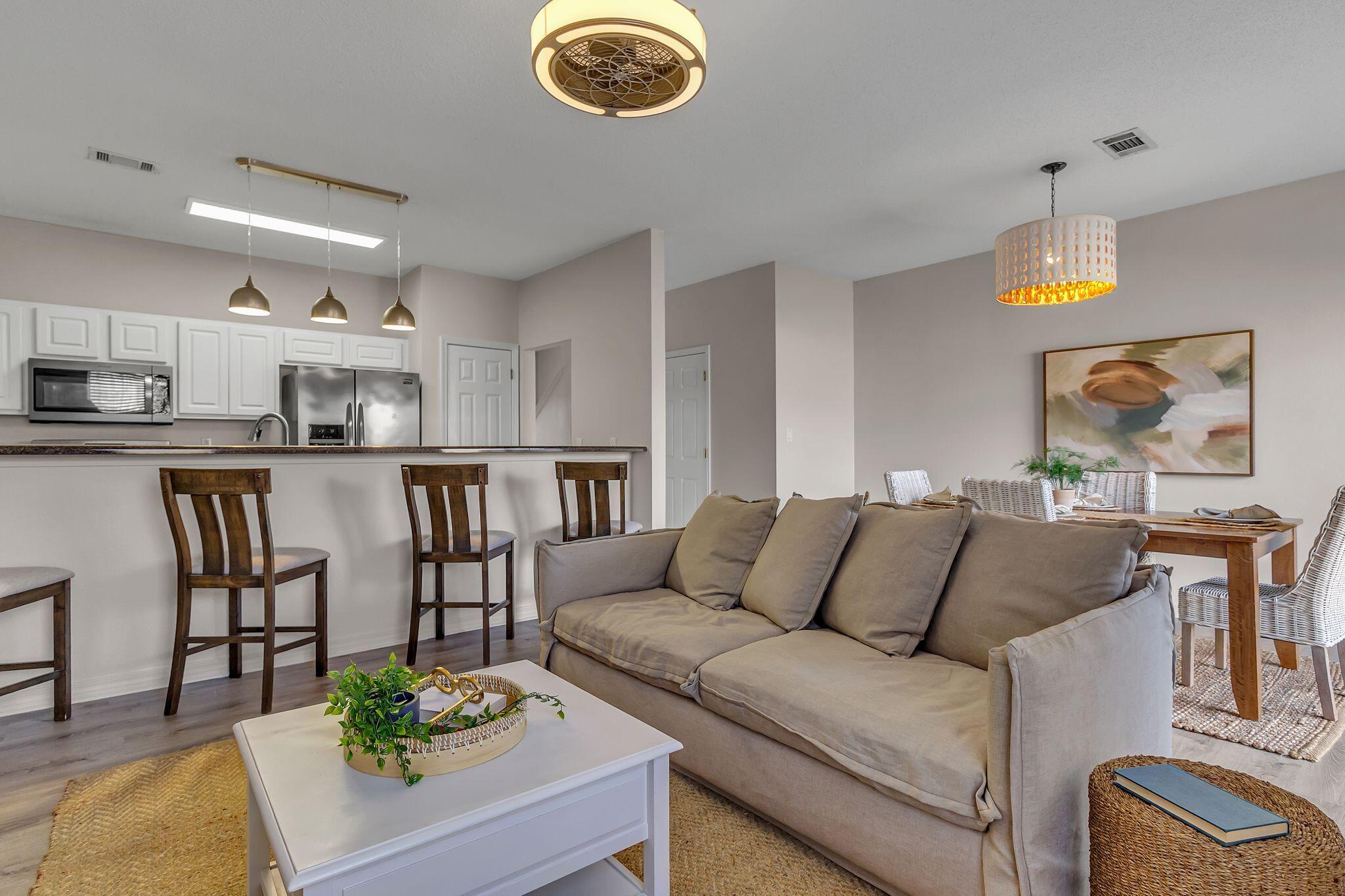 150 Bent Arrow Drive, Unit 51 Destin, FL 32541 - Photo 4 of 28 a living room with furniture kitchen and a chandelier