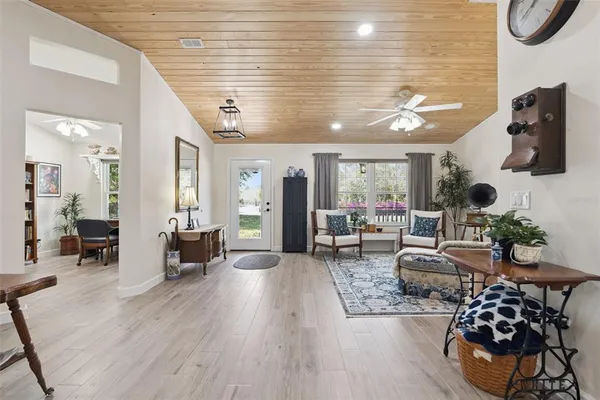 a view of a livingroom with workspace and a window