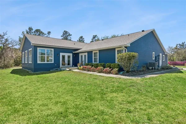 a view of a house with a yard and pathway