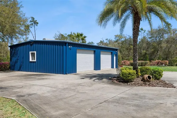 an aerial view of a house with a yard and lake view