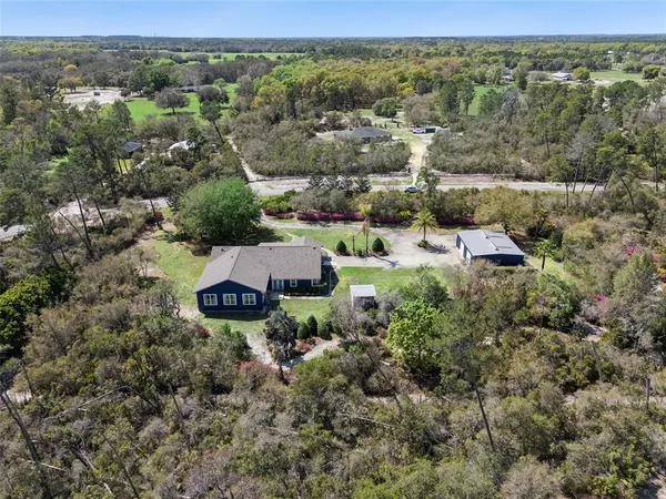an aerial view of a house with a yard