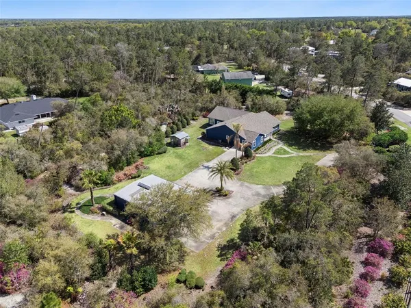 an aerial view of a house with a yard