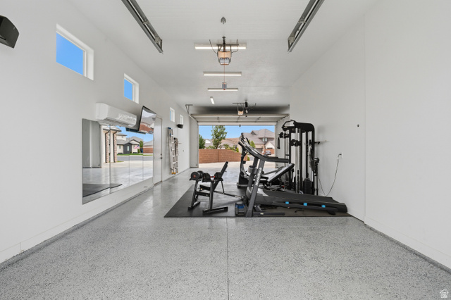 2278 Tawny Ridge Circle St. George, UT 84790 - Photo 49 of 61 Spacious garage with epoxy flooring, white walls, and high ceilings.