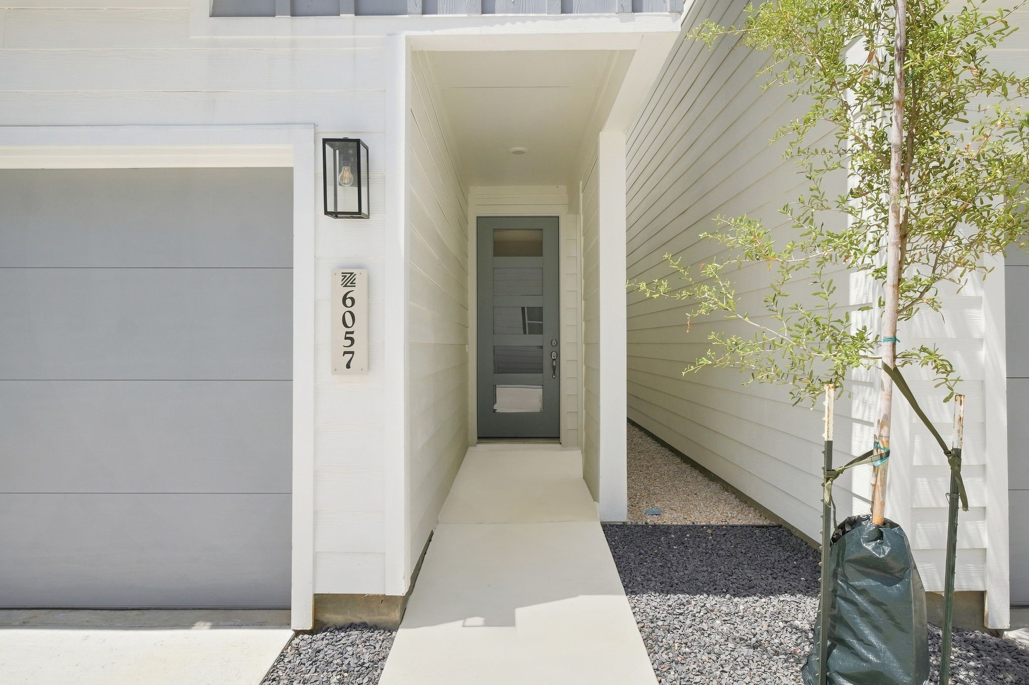 6057 Cebra Street Houston, TX 77091 - Photo 3 of 42 Modern front entry featuring a covered approach, contemporary exterior finishes, and convenient access from the driveway.