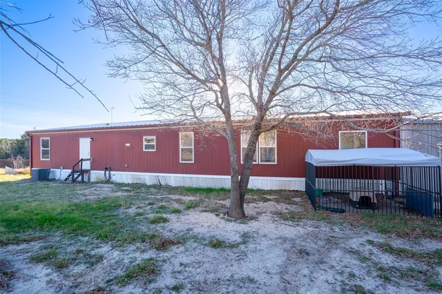 a bed sitting in a bedroom next to a bathroom