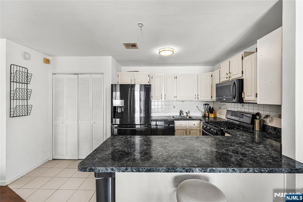 84 Union Street Newark, NJ 07105 - Photo 3 of 39 a kitchen with stainless steel appliances granite countertop a sink stove and refrigerator