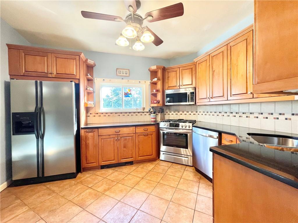 48 Perry View Avenue Pittsburgh, PA 15214 - Photo 7 of 24 a kitchen with stainless steel appliances granite countertop a refrigerator a stove and a sink with cabinets