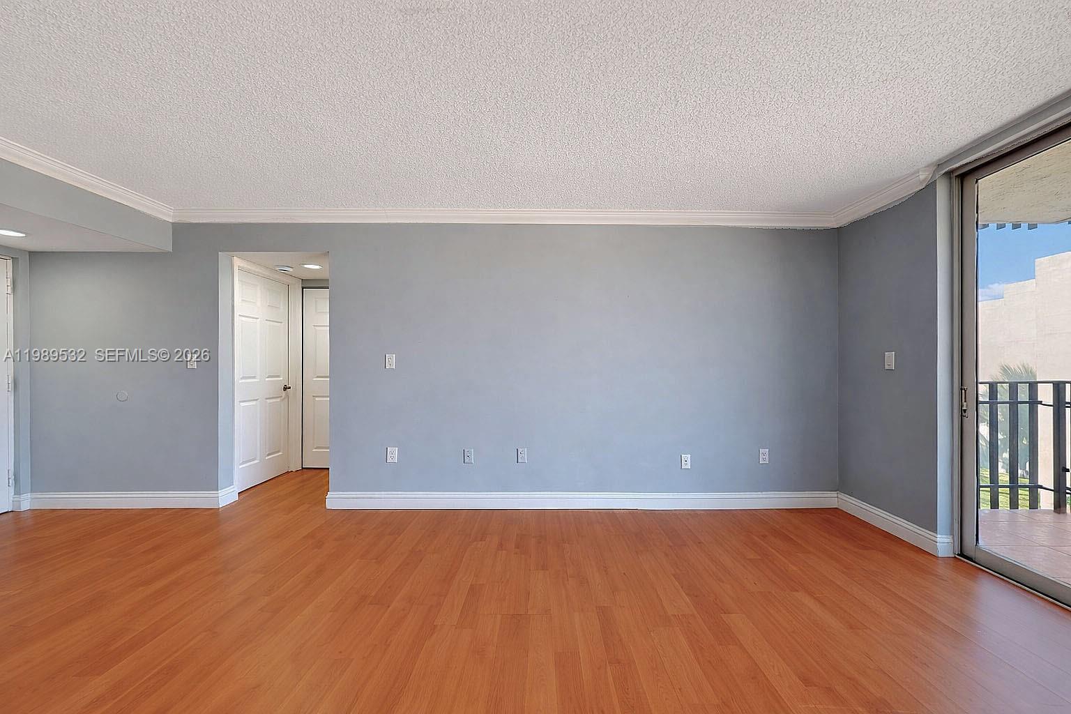 3581 Southwest 117th Avenue, Unit 5308 Miami, FL 33165 - Photo 13 of 38 a view of an empty room with wooden floor and a window