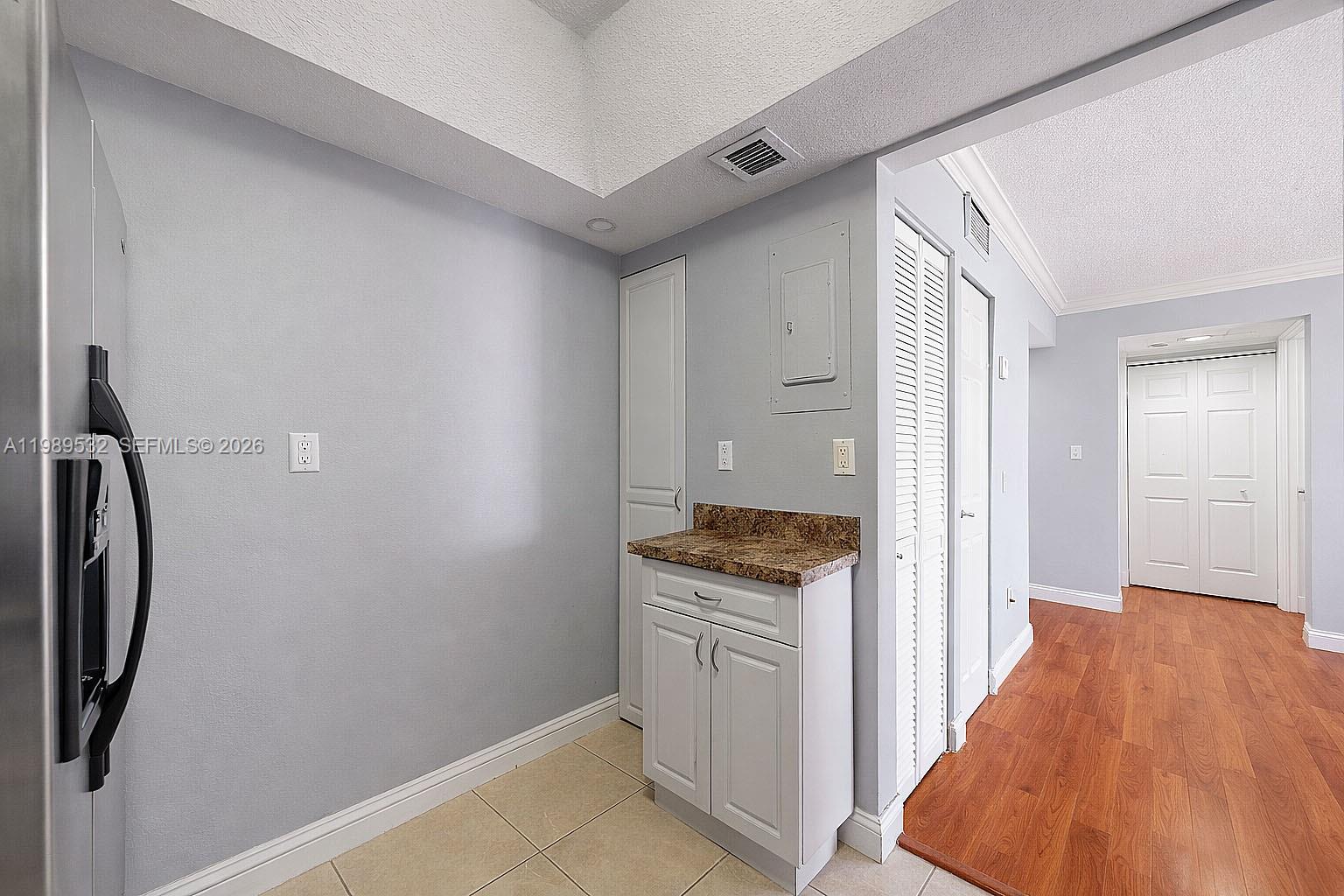 3581 Southwest 117th Avenue, Unit 5308 Miami, FL 33165 - Photo 15 of 38 a view of a kitchen from the hallway